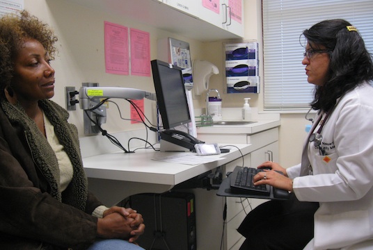 Betty Robinson Winstead of Ellenwood, Ga., describes her symptoms to Dr. Hogai Nassery during a recent office visit at North DeKalb Health Center. 