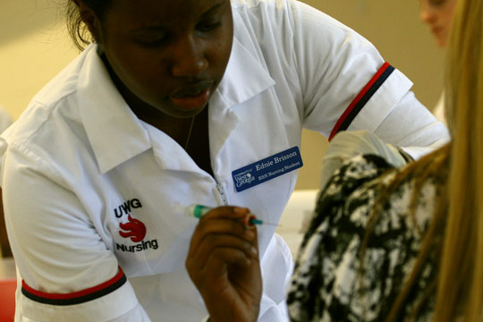 A University of West Georgia nursing student administers a flu vaccine to a patient. The university's School of Nursing says it could only accept 120 students this year, partly because it lacks enough faculty to admit more. Photo shot by Steven Broome, UWG Office of Communications and Marketi