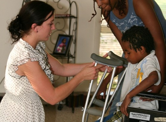 Lauren O'Brien (left) helps an unidentified family through her nonprofit Embraced organization. 