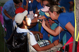 A farmworker gets a dental exam at "Camp Las Vegas."