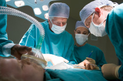 Three Surgeons Operating On A Patient