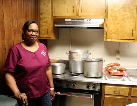 Barbara Haynes, a community health partner, works in the kitchen during a party at Shiloh Baptist Church in Athens.