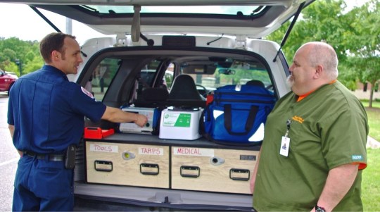 Michael Vieira (left), a Hall County paramedic,  checks supplies in a paramedicine vehicle with nurse practitioner Danny Webb.