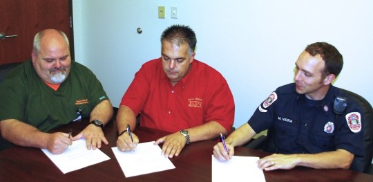 (L to R) Danny Webb, nurse practitioner; Fire Chief David Kimbrell; and paramedic Michael Vieira review paramedicine updates.  