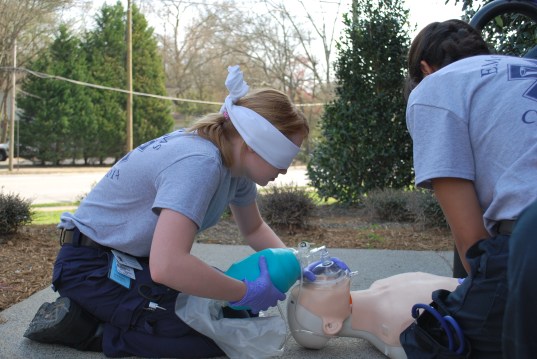 Emory EMT student Elizabeth Rodgers learns to use all of her  senses during a simulation exercise. 