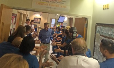 Dr. Kent Brantly gives high-fives to Emory staff when leaving isolation chamber.