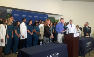 Dr. Kent Brantly appears with Emory physicians, nurses and staff as he speaks to the media.