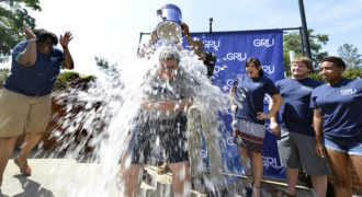 Georgia Regents University President Ricardo Azziz gets an ice water bath to support ALS research.