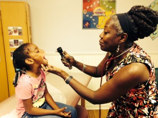 Dr. Evelyn Johnson examines a patient in her Brunswick office. 