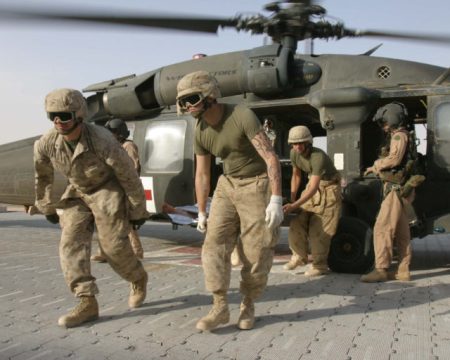U.S. Marines carry a wounded comrade for medical treatment in Iraq.