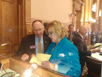 Rep. Allen Peake and Sen. Renee Unterman confer before a vote on House Bill 1.