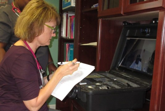 Kemberly Smith conducts a home visit with David Smith through a telemedicine kit. 