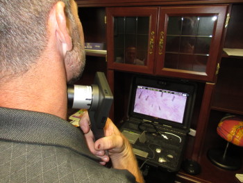 Sam Stephenson of the Georgia Partnership of TeleHealth demonstrates the magnification power of the camera/scope