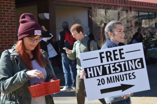 UGA students Amanda Peclat-Begin (left) and Madison Whelchel advertise a free HIV testing event and free condoms at the Tate Center at UGA. 