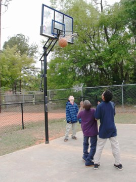 After homework and group activities, kids head outdoors to play basketball. 