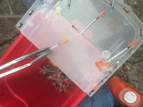Used needles being collected.